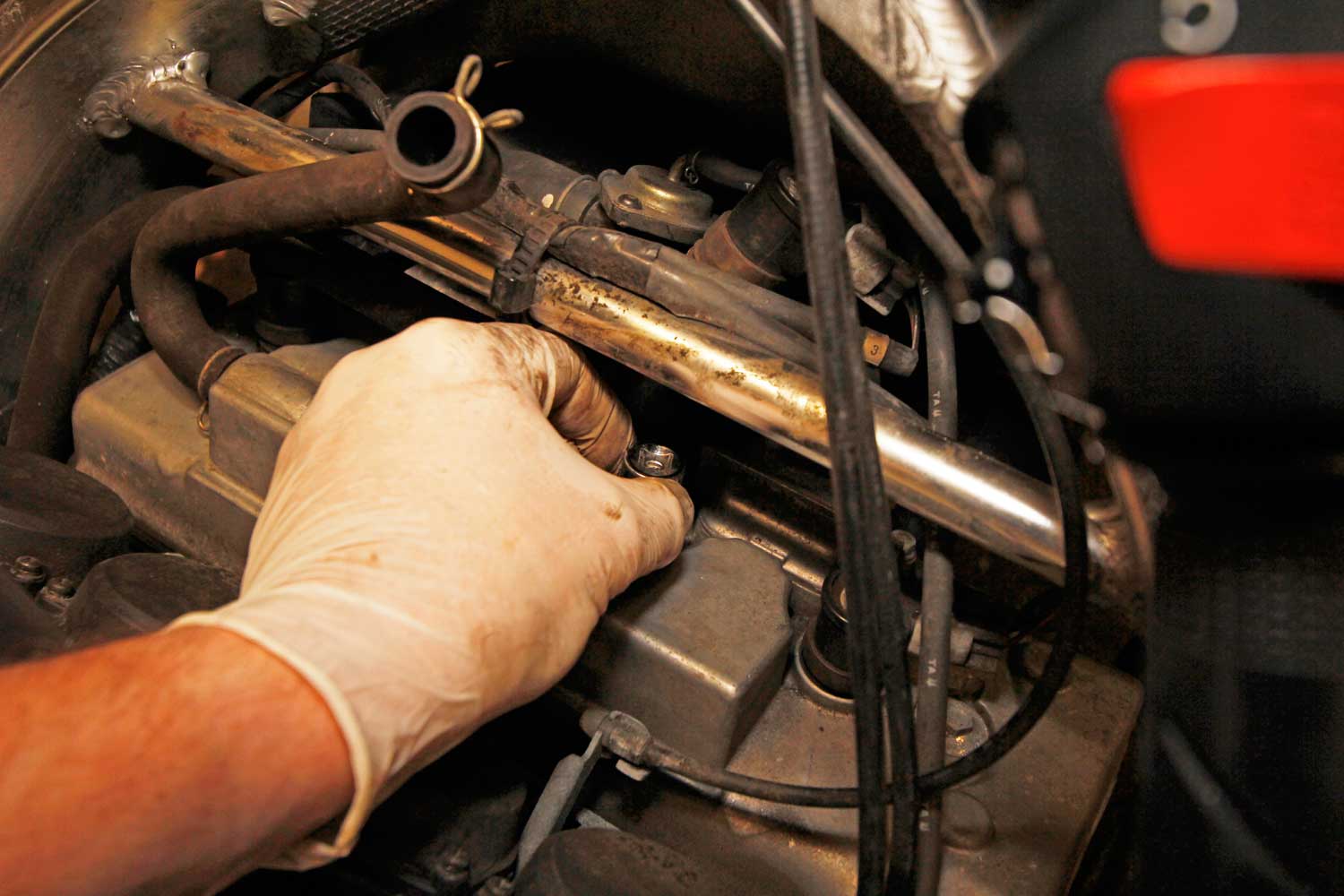 10: With an extension on the socket, but NO ratchet, gently lower the plug into the engine, making sure you don’t catch the electrode. Once it’s sitting on the threads, I turn it slowly backwards – as if I’m undoing it – until I feel the plug’s threads drop into the start of the engine’s threads. Then do it up by hand until it gets to the bottom. This is the best way to make sure you don’t cross-thread the plugs, which is a very costly mistake.