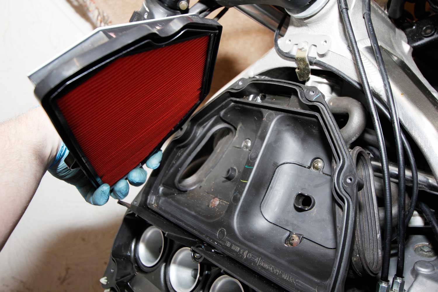 12: With the new plugs in, and the coils firmly seated on the plugs, refit all the pipework, screw the airbox back on then drop in your new air filter. With the air box reassembled and the tank back on, you’re all finished. Job done!