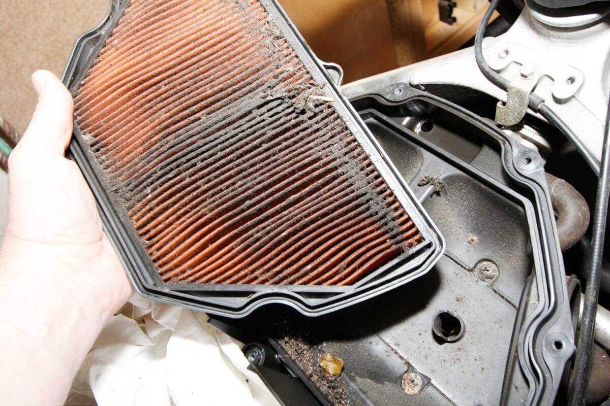 3: This is nasty. The filter’s only just past its scheduled service, but it’s packed with dead flies and road muck. Chuck it away, and carefully clean any rubbish out of the bottom of the air box.