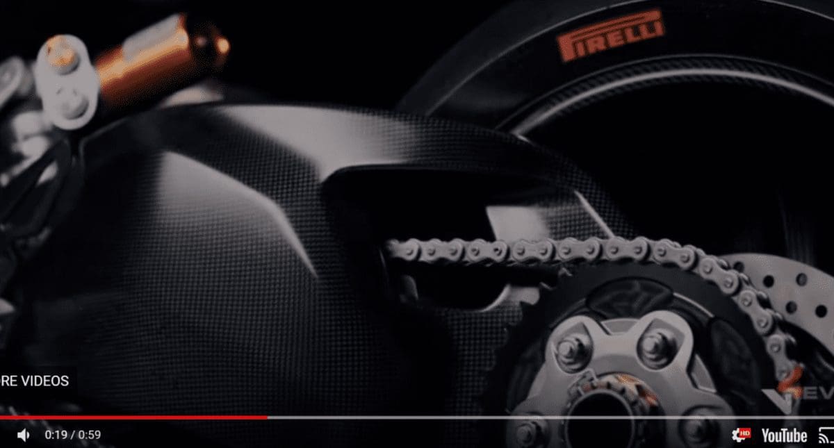 The massive carbon single-sided swing arm is clearly visible in the video.
