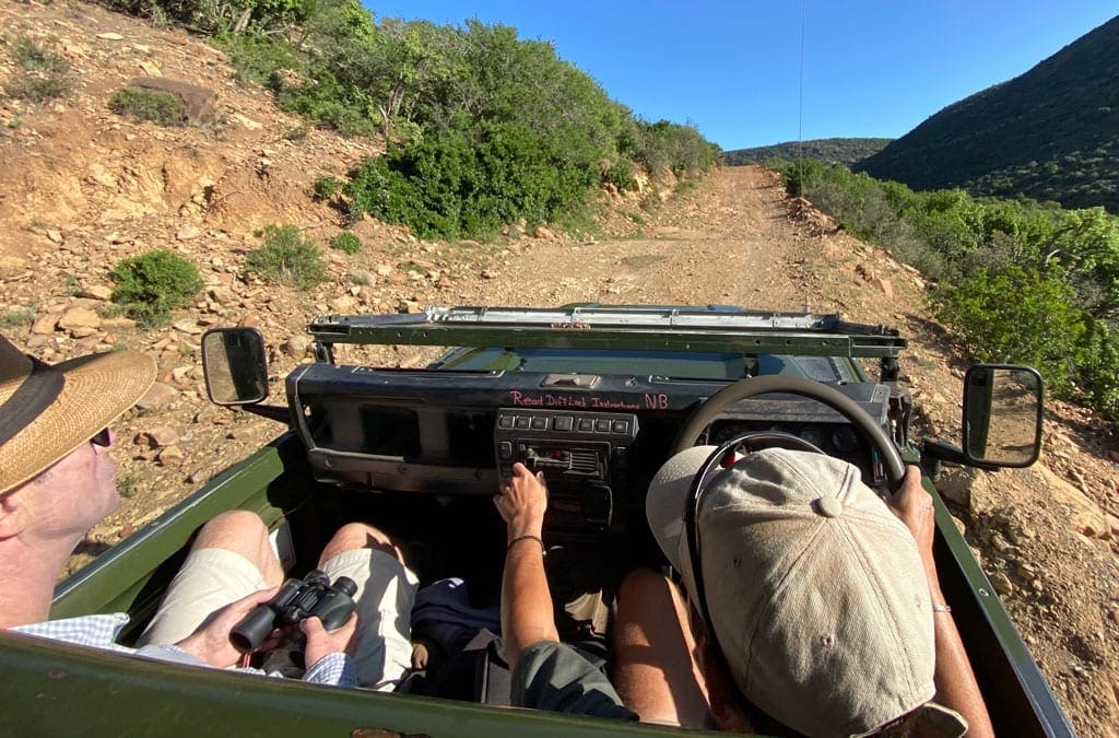 Turning back 4 The group drive a small jeep along a small dirt road.