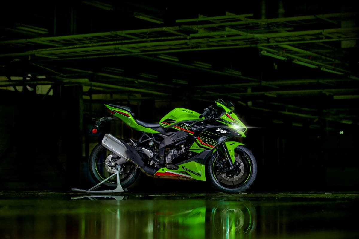 2024 Kawasaki Ninja ZX-4R from the side in a dark industrial building.